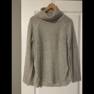 Light grey turtleneck sweater.